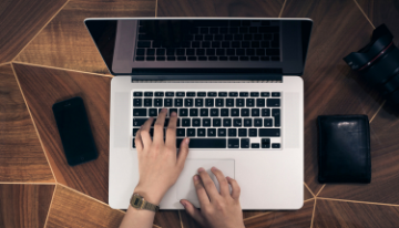 Hands working on a laptop
