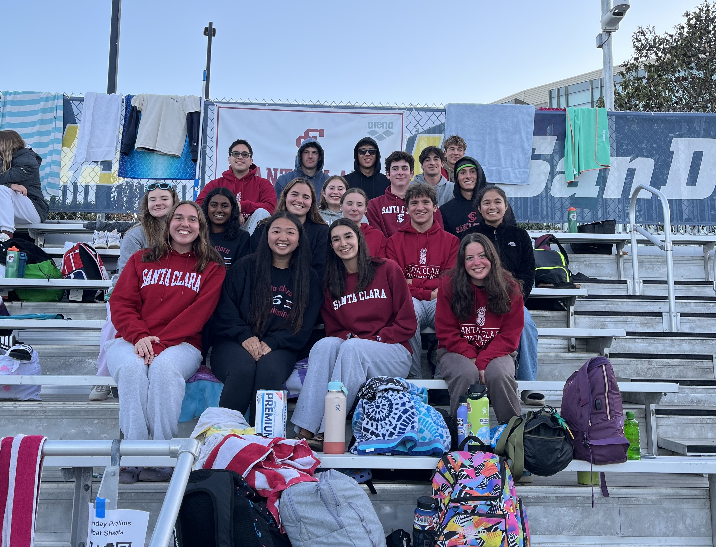 Swim Team members sitting on bleachers