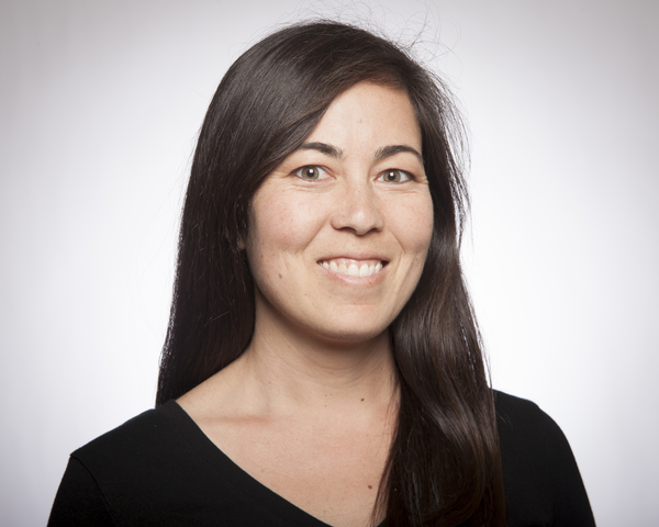 A smiling person in a black top.