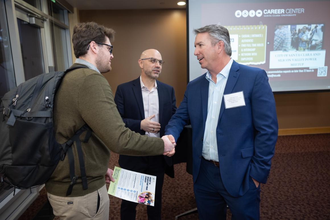 SSCU student shaking hands with a business professional.