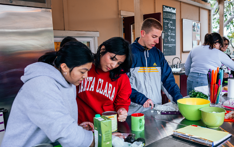 Students preparing a Nourish Nights Meal in the Forge Garden Outdoor Kitchen. image link to story