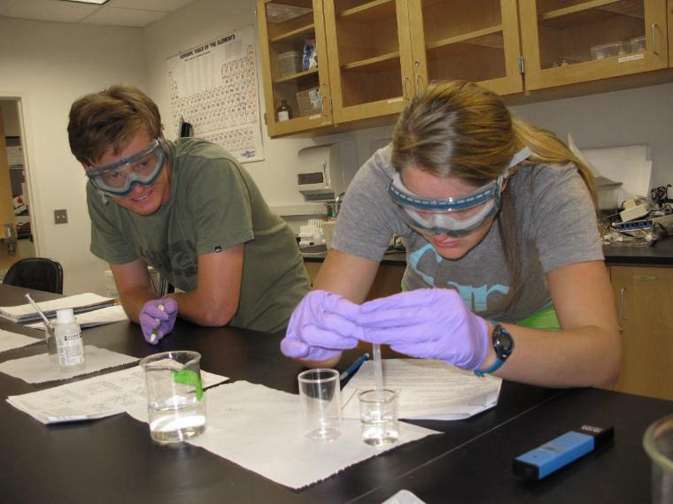 Two students working in a science lab
