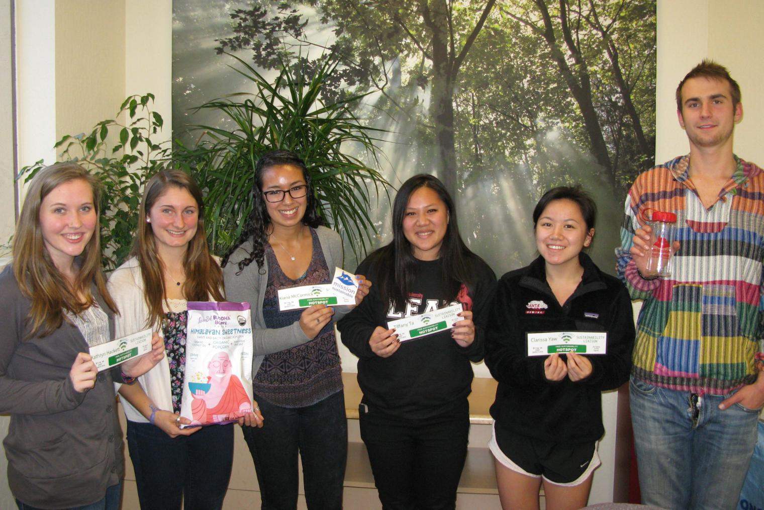 A group of students holding up Center for Sustainability and Sustainability Liaison signage