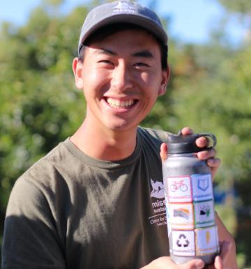 James with reusable water bottle and playbook badges