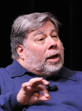 A man speaking and gesturing with his hand. image link to story