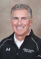 A person smiling in sportswear with a 