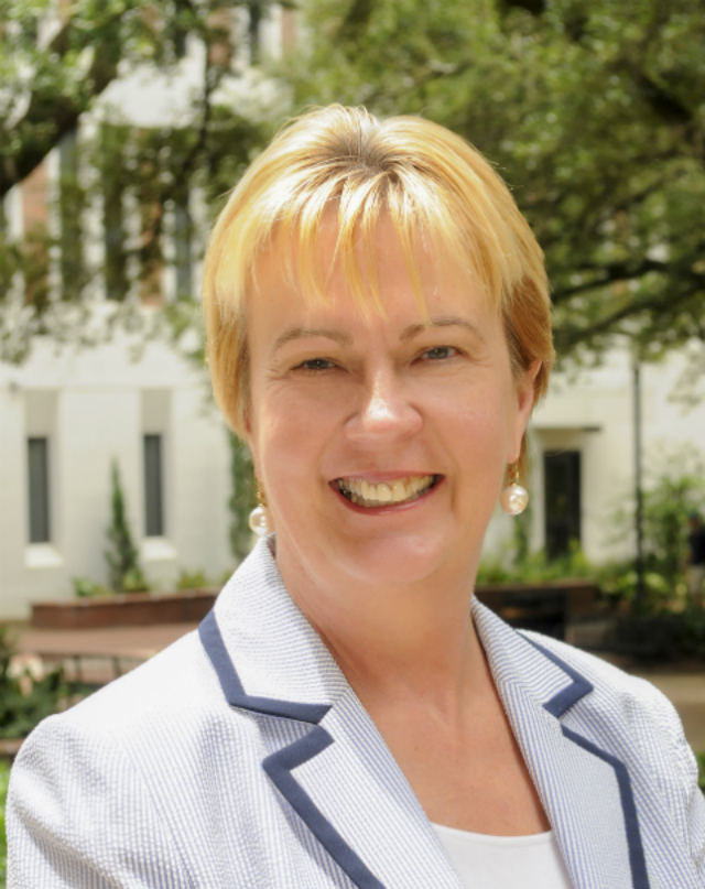 A person smiling in an outdoor setting. image link to story