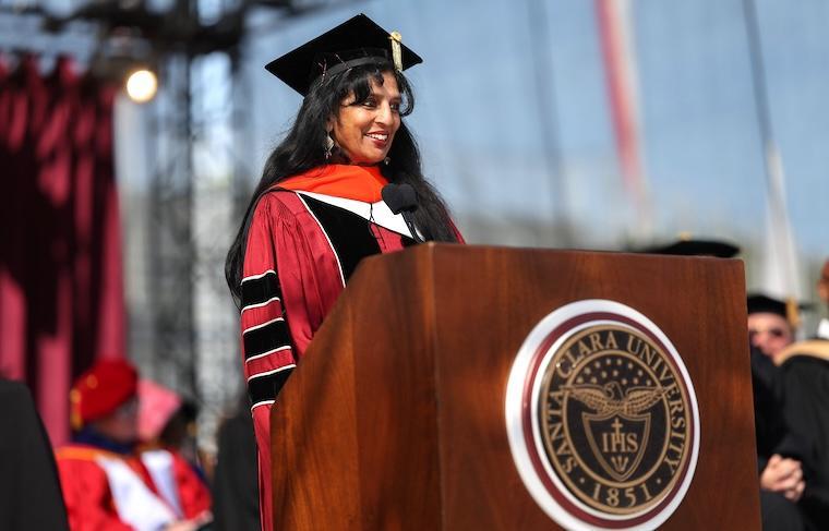 Jayshree Ullal stands at a podium to address graduates
