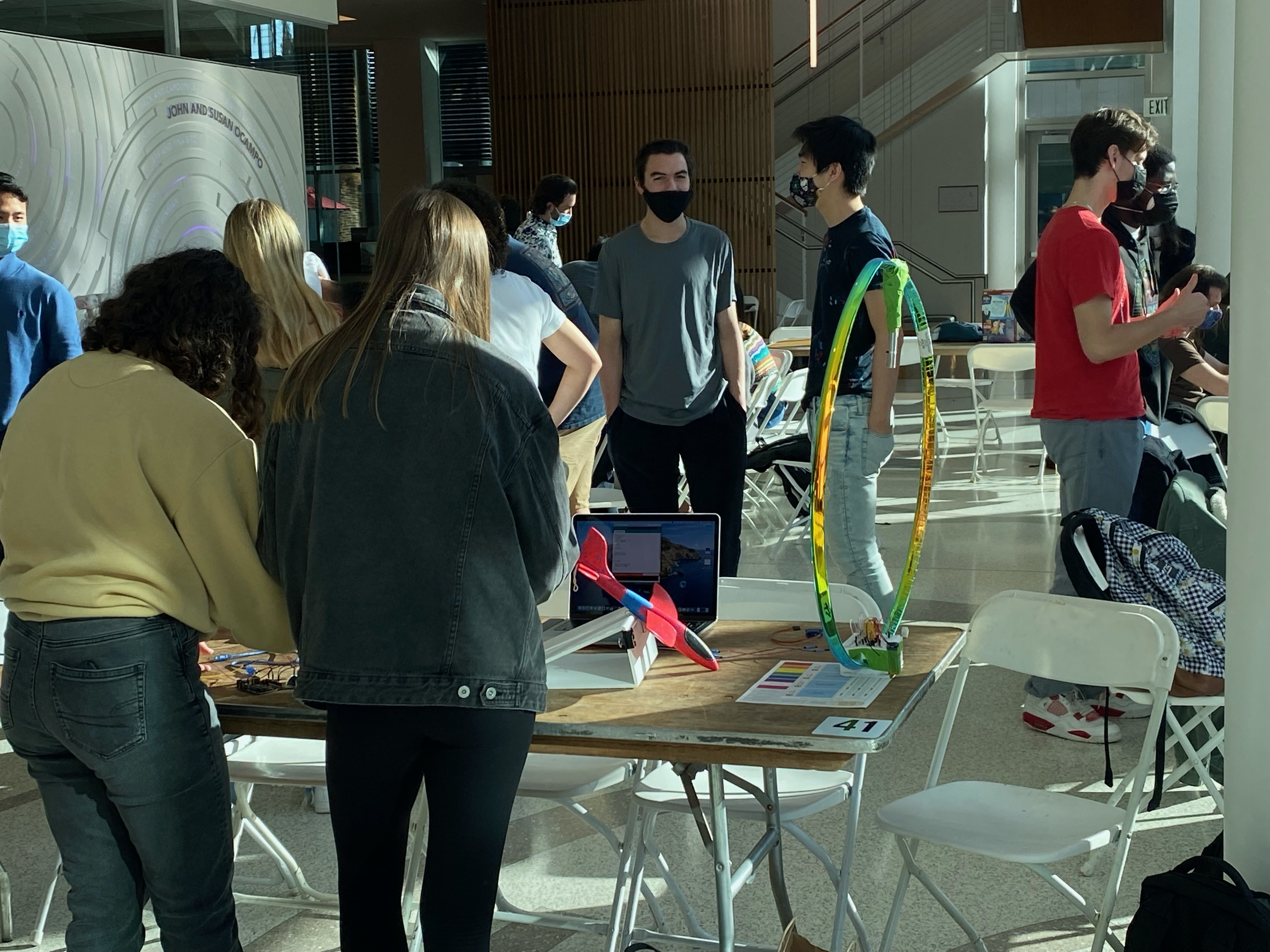 People attending a robot show in an indoor setting.
