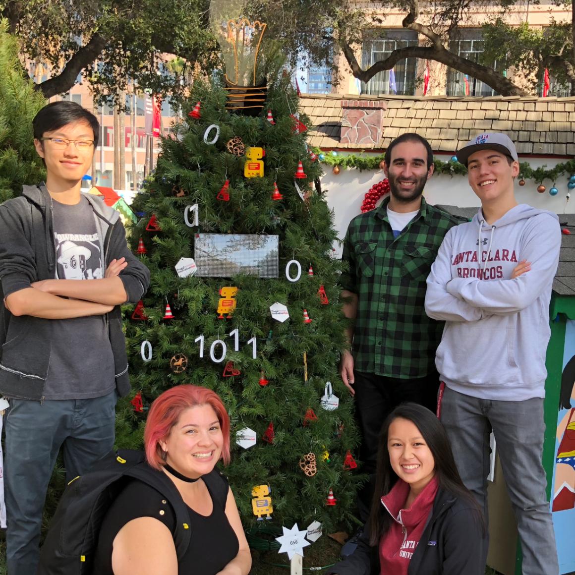 Nicole Morales and students with tree at Christmas in the Park