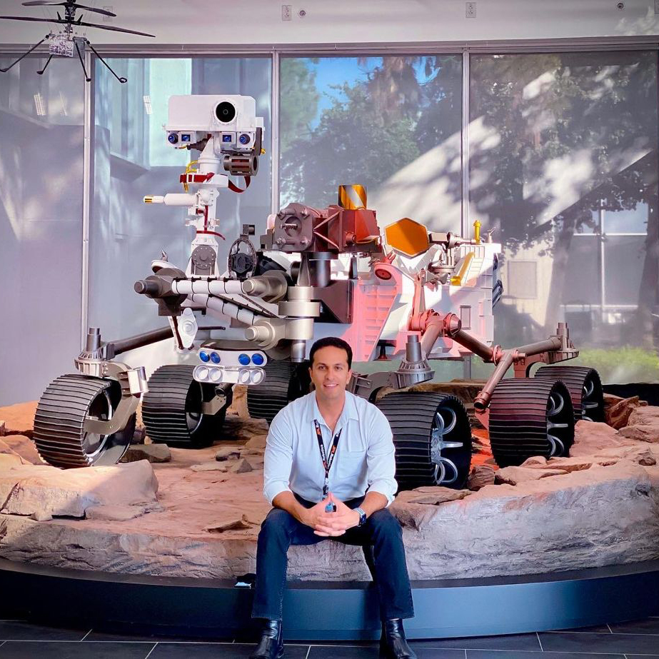 A photo of alum Kamak Ebadi sitting in NASA's Jet Propulsion Lab