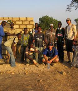 A diverse group of people standing outdoors together.