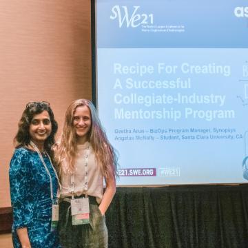 Angelus McNally stands with co-presenter at the SWE21 Conference.