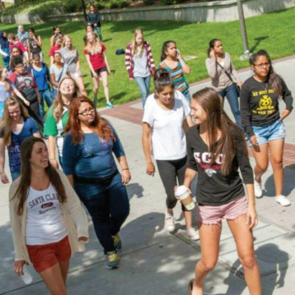 SCU women students lead a group of middle school girls to a fun activity on campus