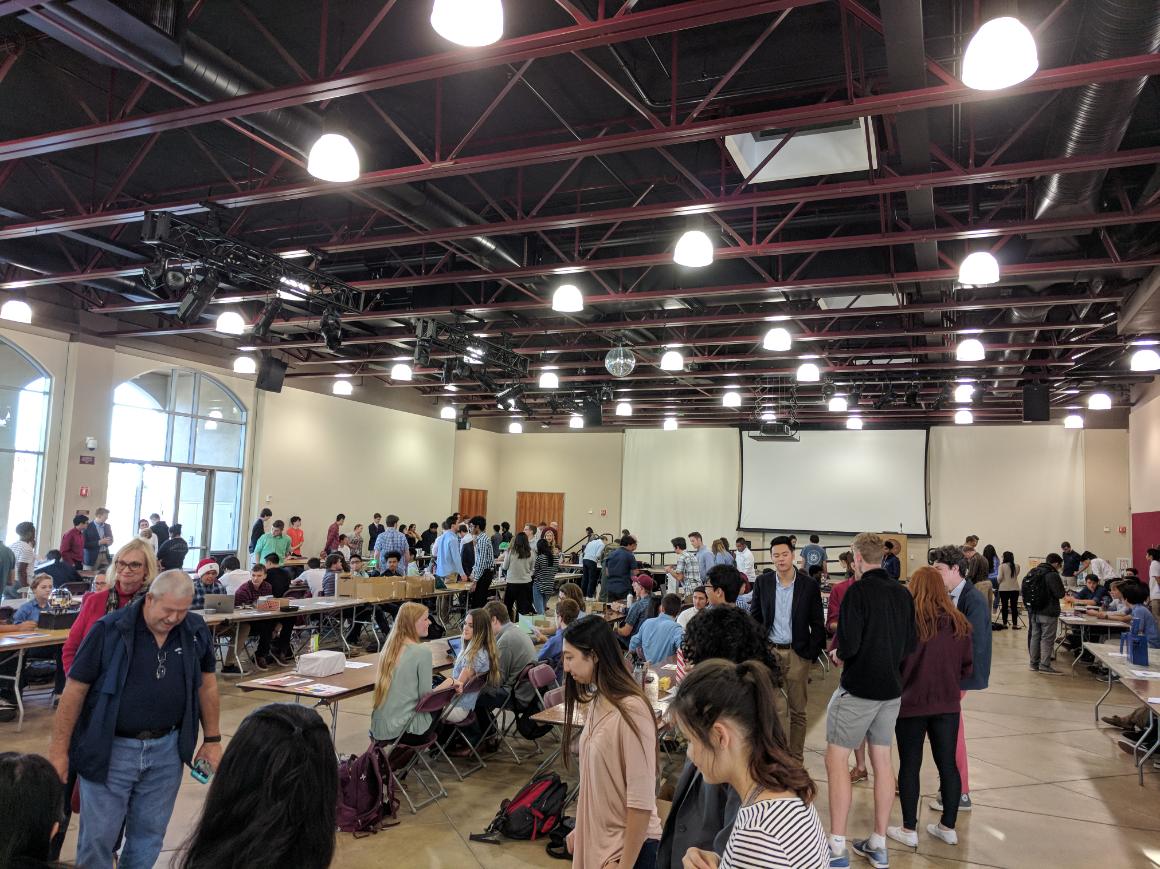Alt text: People attending a robot show in a large indoor space.
