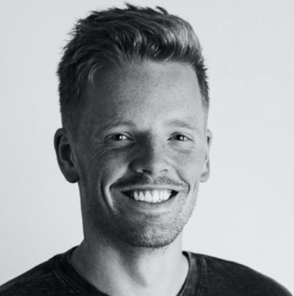 Black-and-white portrait of a smiling person named Sam Bertram. image link to story