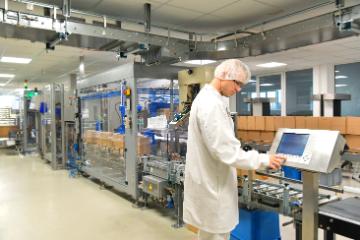 Worker in biopharmaceutical manufacturing plant at a computer image link to story