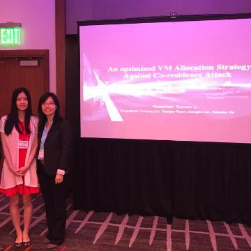 Two people in front of a screen displaying 