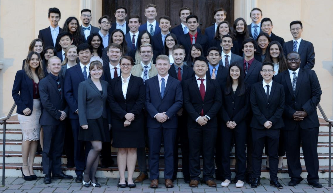 A group photo of Theta Tau Chapter members in formal attire.