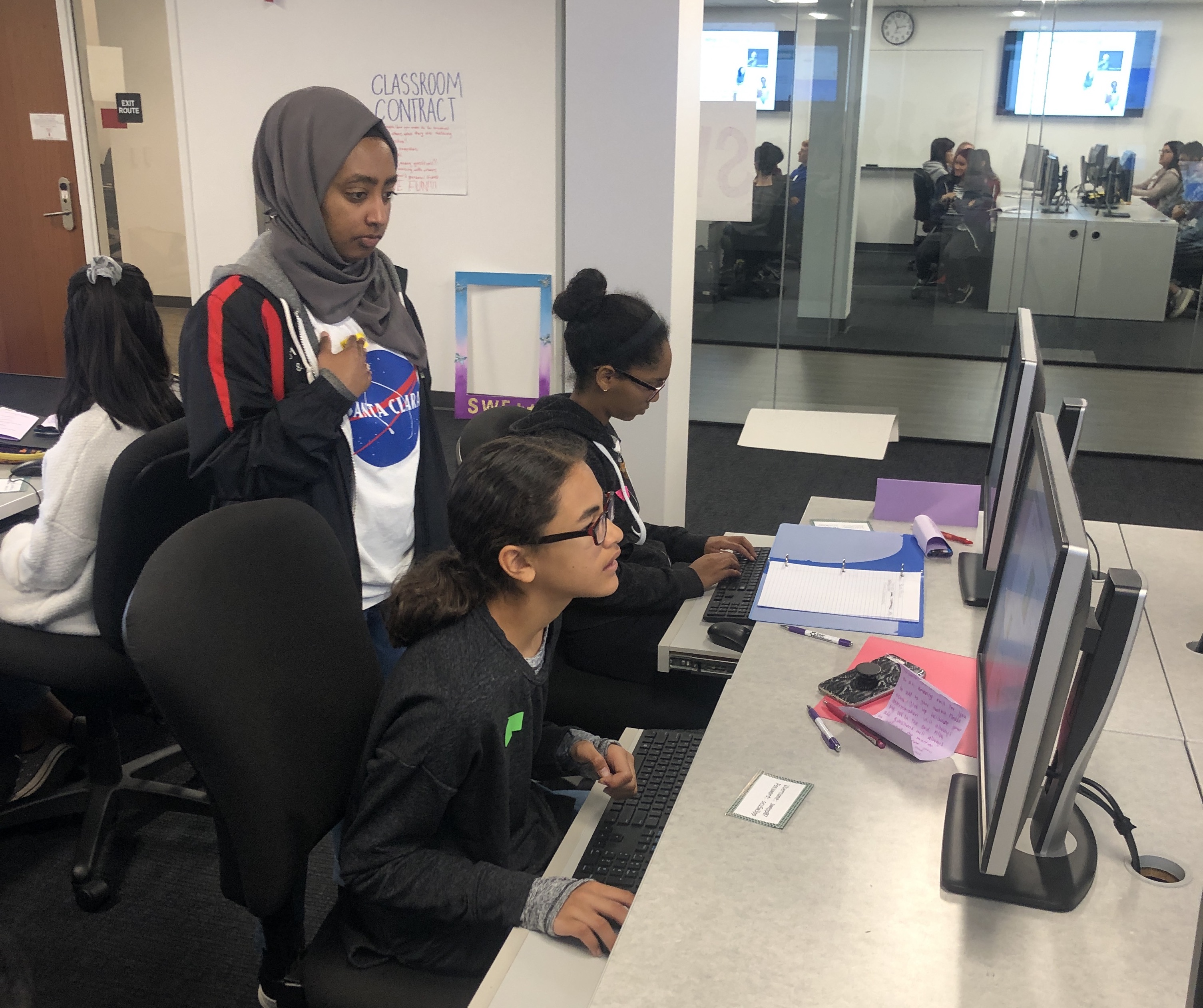 SWE++ team member helping students with their coding