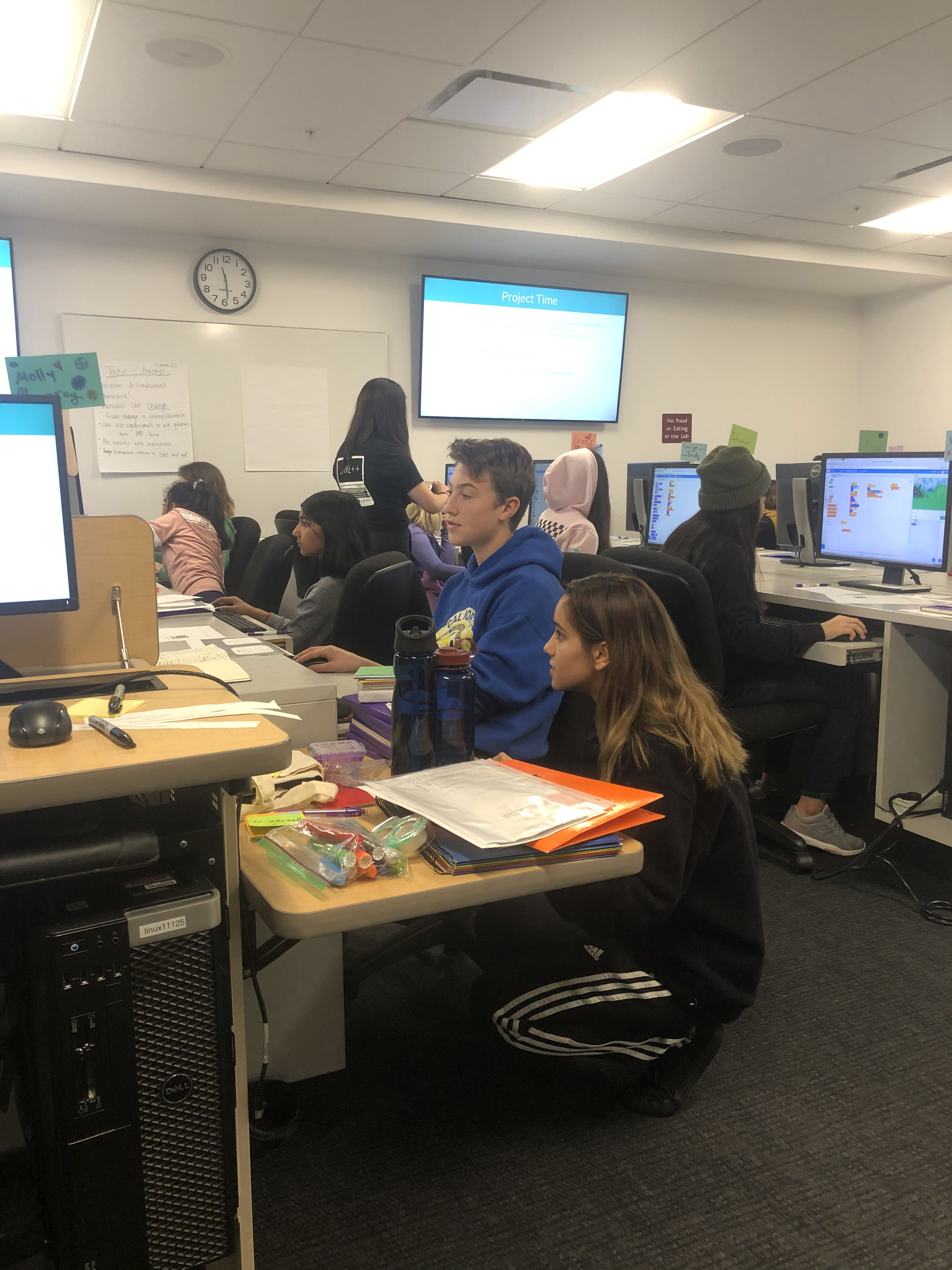 SWE++ TA providing one-on-one help to young student participant