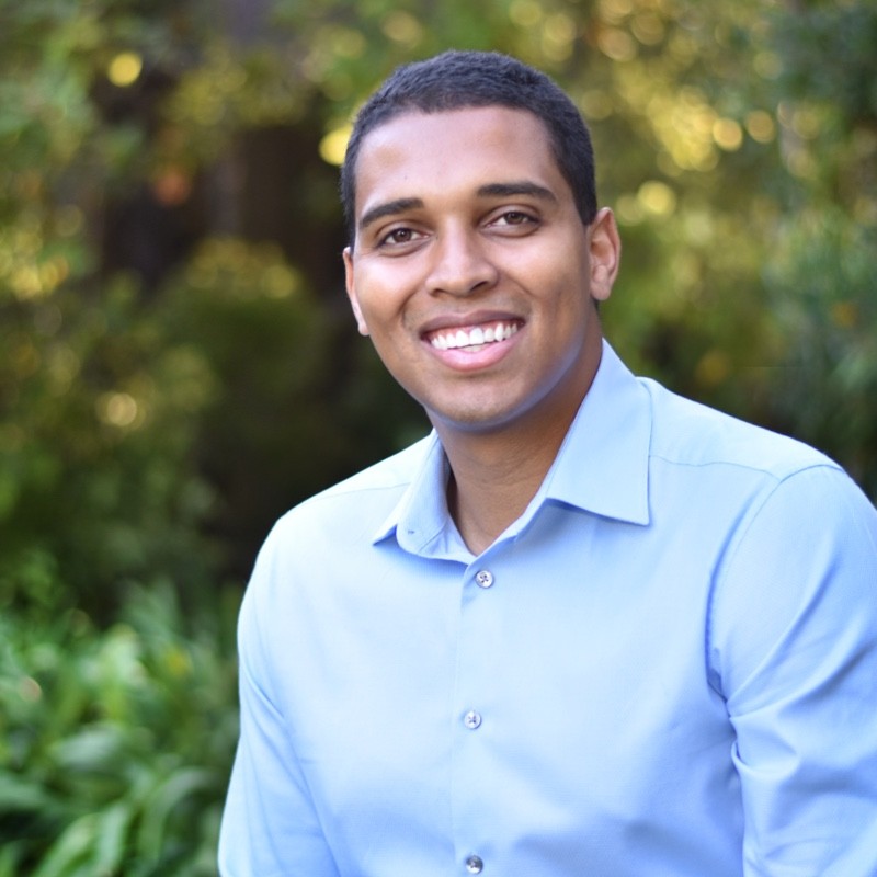 professor Ajwang Rading a man with close cropped brown hair wearing a blue button down shirt