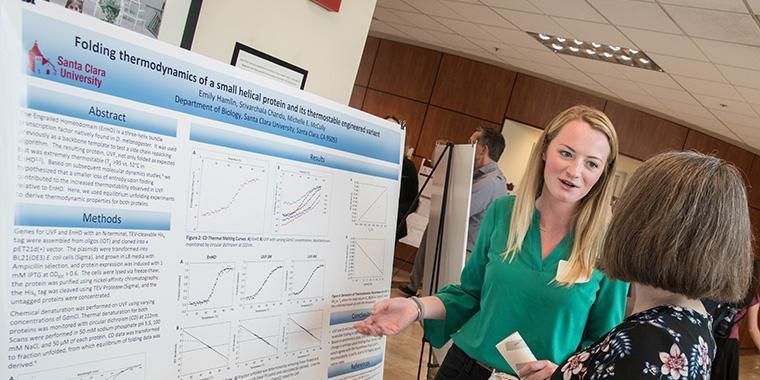 A students presenting in a research showcase 