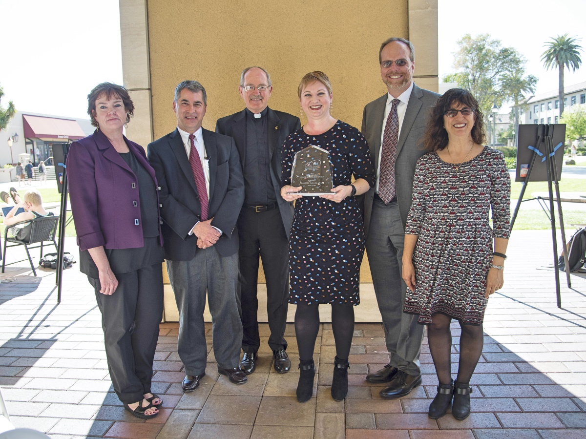 Barbara Kawecki, Bob Owen, Fr. Michael Engh, S.J., Jennifer Nutefall, Dennis Jacobs, and Irene Herold pose with the trophy at the award ceremony